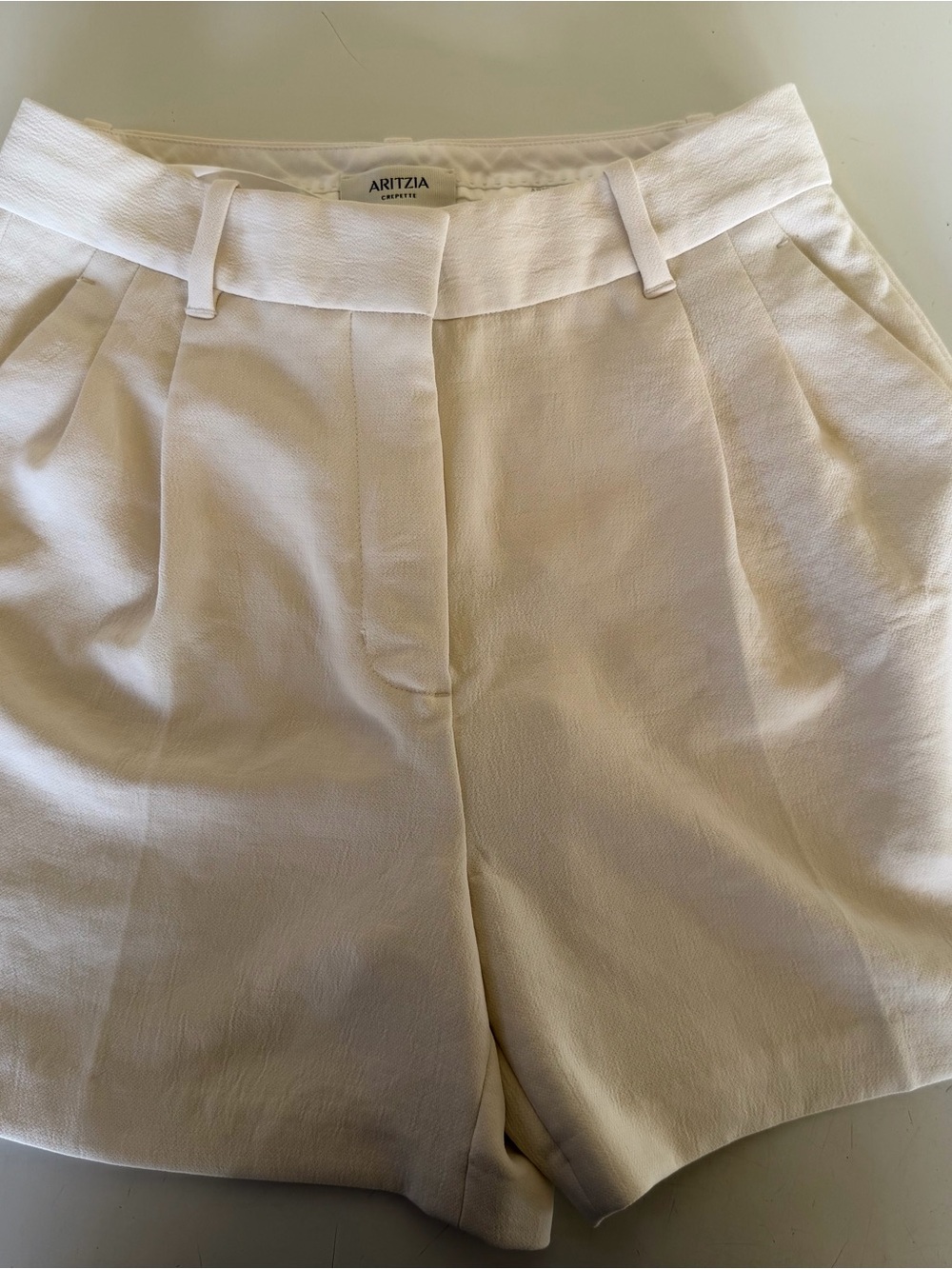 Aritzia Pleated High-Waist Cream Shorts